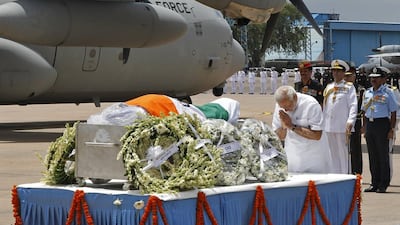 Indian prime minister Narendra Modi pays tribute to the former Indian president APJ Abdul Kalam during a wreath laying ceremony at New Delhi airport. Reuters