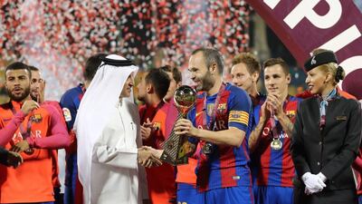 Andres Iniesta receives the trophy after Barcelona win the Match of Champions. Karim Jaafar / AFP