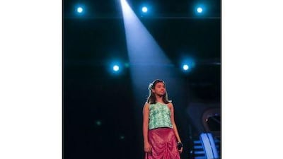 Rima Chakravorty, 14, waits for her cue before the start of her performance during the taping of the musical reality show Sa Re Ga Ma Pa Lil Champs inside a studio in Mumbai. Danish Siddiqui / Reuters