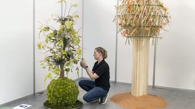 Ilona OoStenveld, of Netherlands, tends to her floral arrangements at Dubai International Flower Festival. Reem Mohammed / The National