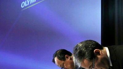 Shuichi Takayama, the president of Olympus, left, and Nobuyuki Onishi, an official of company's accounting division, bow at the end of a news conference in Tokyo last year. Olympus' leadership was accused of breaking Japanese law and hiding investment losses. Kim Kyung-Hoon / Reuters