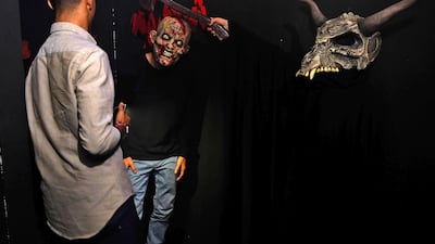 Saudi youths wearing masks play at "House of Terror", an entertainment activity now accessible to men and women during the the holy month of Ramadan in the Saudi Red Sea resort of Jeddah. AFP