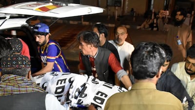 The body a man from a Christian family, who was killed by unidentified gunmen, is taken into an ambulance at a hospital morgue in Quetta. REUTERS/Naseer Ahmed