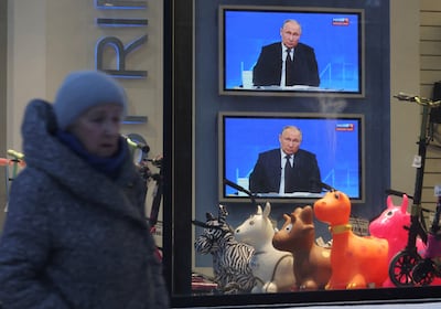 Screens in Saint Petersburg broadcast President Vladimir Putin's annual end-of-year press conference. Reuters