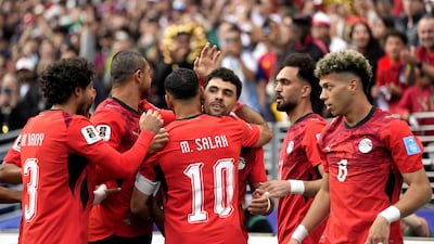 Mahmoud Saber, centre, of Egypt celebrates with teammates after scoring the opening goal against Iran in Seattle. EPA
