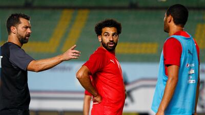 Salah listens to a member of Egypt's coaching staff during a training session in Cairo. Reuters