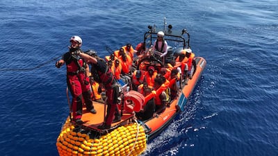 A "rhib", an inflatable dinghy, belonging to the 'Ocean Viking' rescue ship, operated by French NGOs SOS Mediterranee and Medecins sans Frontieres (MSF), transports migrants rescued from their dinghy during an operation in the Mediterranean Sea on August 12, 2019 AFP