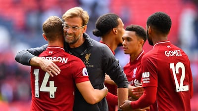 Liverpool manager Jurgen Klopp celebrates with Jordan Henderson after securing a 2-1 win over Tottenham Hotspur at Wembley. Reuters