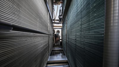 Renewable energy-based solutions to everyday problems are increasingly deployed throughout the Middle East. In Gaza, Palestine, an engineer checks the filters in a solar-powered water generator. AFP