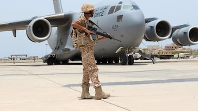 A UAE soldier guards a military plane at Aden airport. Reuters.