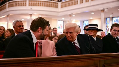 Mr Trump speaks with vice president-elect JD Vance during a church service at St John's. AFP