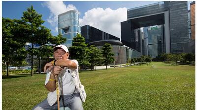 Top, "Uncle" Wong, 90, attends a rally to demand greater democracy in Hong Kong on September 24, 2014, and bottom, Mr Wong at the same location on September 23, 2015. He said: "I have taken part in pro-democracy protests since the 1980s. If I'm too old to walk and attend the next major one, I hope someone would carry me there." Reuters