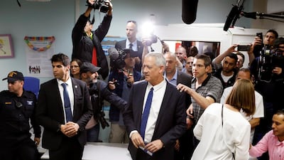 Benny Gantz, leader of Blue and White party, is surrounded by members of the media as he votes at a polling station as Israelis began voting in a parliamentary election. Reuters
