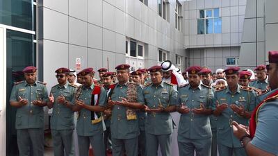 Members of the Special Security Forces and Abu Dhabi Department for Residency and Foreigners’ Affairs offer prayers for hero comrades during a Commemoration Day event on Wednesday. Courtesy Security Media