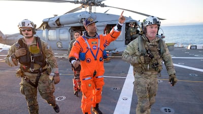 Crew member Victor Glover gestures aboard the recovery ship after being extracted from the Artemis II capsule by recovery personnel in the Pacific Ocean. EPA