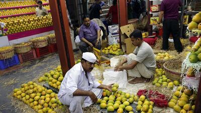 An Indian shopkeeper arranges mangoes in a fruit market in Mumbai on May 3. India recognizes the mango as its national fruit and is the world's largest mango producer. Rajanish Kakade / AP