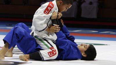 Adam Chowdhury, in blue, of Britain, goes up against Hamdan Hamid Al Ketbi, of the UAE, in the semi-finals match for the boys 38kg class at the Abu Dhabi World Jiu-Jitsu festival on Wednesday, April 12, 2017. Jeffrey E Biteng / The National
