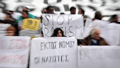 Demonstrators hold placards during a march against racism in Athens. Europe is seeing the gradual mainstreaming of racist ideas. AFP