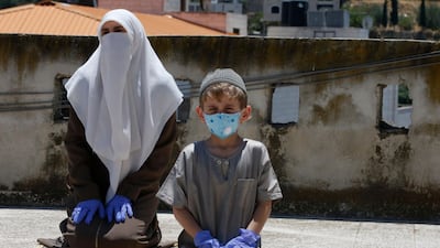 Members of the family of an imam at a local mosque, perform their Friday prayers on the rooftop of their house, after the authorities shut down mosques due to the coronavirus pandemic, in the West Bank town of Hebron. AFP