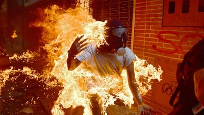 A demonstrator catches fire during clashes with riot police during a protest against Venezuelan President Nicolas Maduro in Caracas. Ronaldo Schemidt / AFP Photo / May 3, 2017