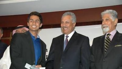 Dubai 16-year-old Shorye Chopra, left, accepts an award as top junior cricketer and a handshake from former Pakistan international player Zaheer Abbas, centre, as Shyam Bhatia looks on.