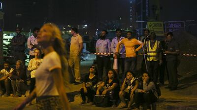 Police blocked off areas around the Torch skyscraper, which still had power. Lights were on in many of the apartments inside and multiple fire trucks and police vehicles were on the scene. Sarah Dea / The National