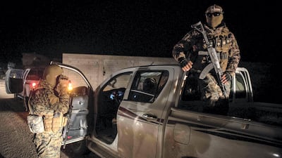 Kurdish YPG fighters stand guard outside Baghouz, Syria as fighting is ongoing to clear the bastion of the last ISIS fighters, 2 March 2019. Campbell MacDiarmid