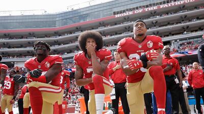 San Francisco 49ers outside linebacker Eli Harold, quarterback Colin Kaepernick and safety Eric Reid kneel during the national anthem before an NFL football game. AP Photo/Marcio Jose Sanchez