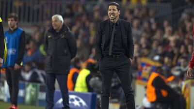 Atletico Madrid manager Diego Simeone, right, gestures during his side's 1-1 Champions League quarter-final first leg draw away to Barcelona on Tuesday night. Alejandro Garcia / EPA / April 1, 2014