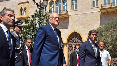 Lebanon's Prime Minister Najib Mikati, centre, has pledged to hold parliamentary elections in 2022. AFP