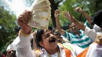 Congress Party supporters celebrate in front of the party's headquarters in New Delhi yesterday.
