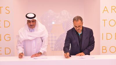 Neom chief executive Nadhmi Al-Nasr (left) signs contracts for the city's new construction village with Al-Tamimi Group and SATCO. Courtesy Neom
