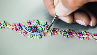 An artist renders the timepiece using the gouache painting method. Courtesy Dior Joaillerie