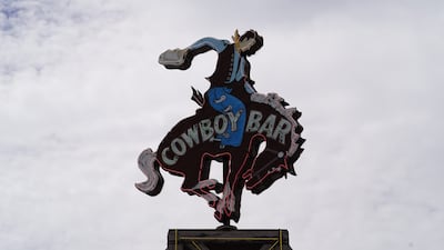 A neon cowboy sign on the roof of a popular bar in Jackson, Wyoming. Willy Lowry / The National