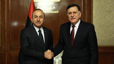 Libya's unity government Prime Minister Fayez Al Sarraj (R) receives the Turkish Foreign Minister Mevlut Cavusoglu in the Libyan capital Tripoli on December 22, 2018. AFP