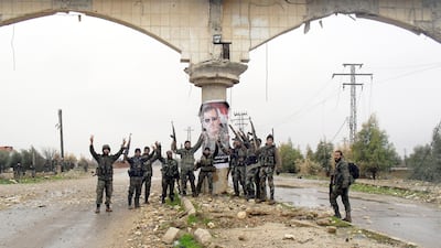 Syrian pro-government forces celebrate on a street in Sheikh Miskeen after retaking the strategic town from rebel forces. Sheikh Miskeen lies at a vital crossroads between Damascus to the north and the government-controlled city of Sweida to the east. AFP