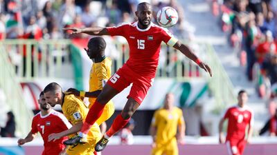 Palestine's defender Abdallatif aL Bahdari jumps for the ball. AP Photo