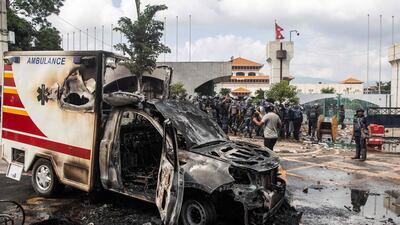 A burnt-out ambulance outside the parliament building. AFP