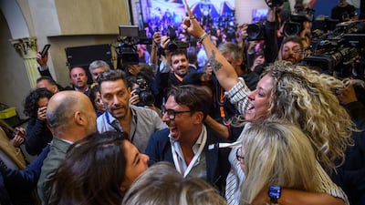 Supporters celebrate at Ms Meloni's press conference. Getty