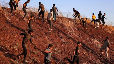 Syrian demonstrators throw stones near a Turkish army observation point in Ibbin Samaan in Aleppo province, on July 1, 2024. AFP