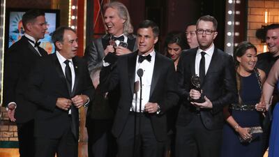Ken Davenport, centre, and the cast and crew of "Once On This Island" accept the award for best musical revival. Michael Zorn / Invision / AP