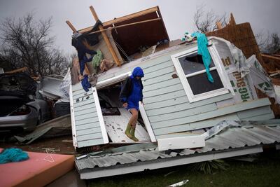 A woman stands on her front door as she surveys her property which was left devastated by Hurricane Harvey in Rockport. Adrees Latif/ Reuters