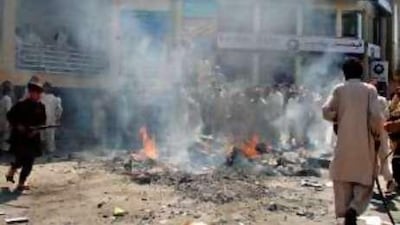 Pakistani protesters burn tyres on a road after police fired at a demonstration in Mingora, the main city in Swat.