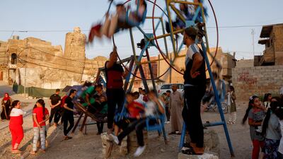 Iraqi children have fun at the fair on the first day of Eid in the old city of Mosul. Reuters
