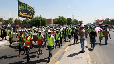 Jobless graduates wear hard hats and fluro vests during a protest near the green zone in central Baghdad, Iraq. EPA