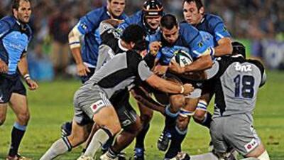 Pierre Spies, centre, the Bulls No 8, is tackled by Bryn Evans and John Schwalger of the Hurricanes during Pretoria's 19-18 win at Loftus Versfeldt last weekend.