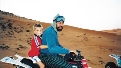 Michael gets a ride on a quad bike with an Emirati man. Courtesy Michael Alcock