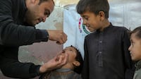 A child receives an anti-polio vaccine during a door-to-door immunisation campaign in Kabul on November 26. The virus remains endemic in Afghanistan and Pakistan. EPA