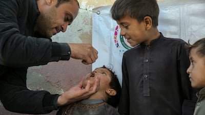 A child receives an anti-polio vaccine during a door-to-door immunisation campaign in Kabul on November 26. The virus remains endemic in Afghanistan and Pakistan. EPA
