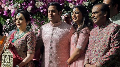 Reliance Industries Chairman Mukesh Ambani, right, his wife Nita Ambani, left, son Akash Ambani and daughter Isha arrive for Akash's wedding in Mumbai, India. Photo: AP